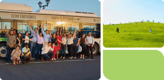 a park with green grass, people sitting, trees, mountains, and a wind turbine on a hill